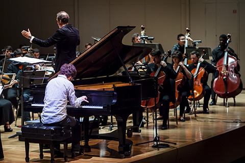 conductor with orchestra in concert